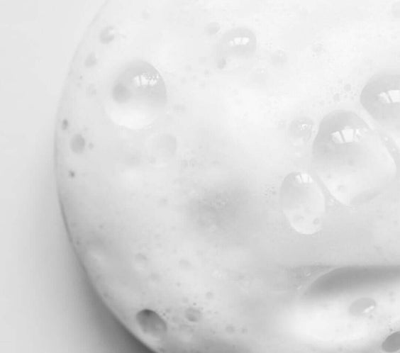 Close-up of a foamy texture, ideal for showcasing product in skincare routines, emphasizing hydration and nourishment.